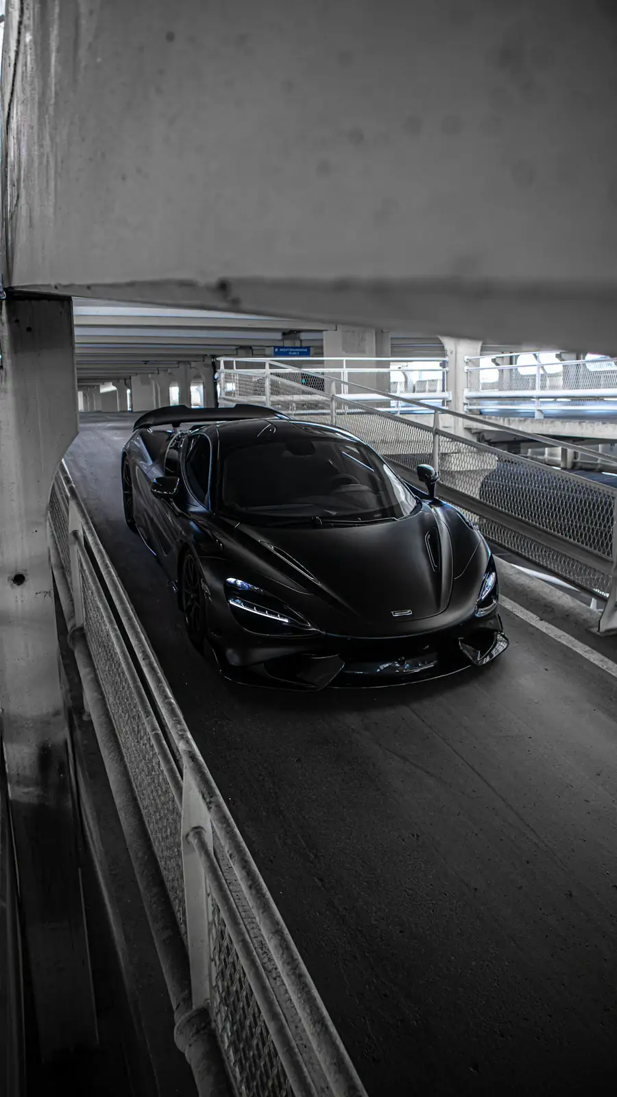 Black sports car on a race track — McLaren program