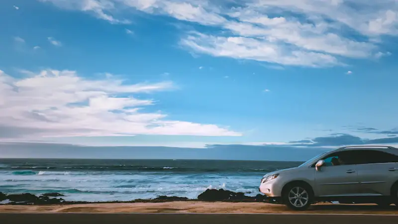 Car parked beside the water — serving Tobago owners