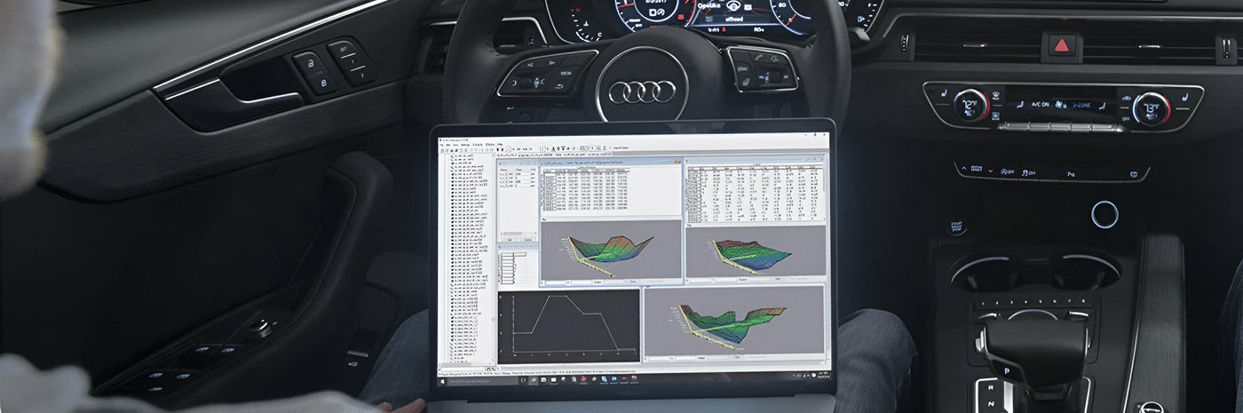 ECU calibration software on a laptop inside an Audi