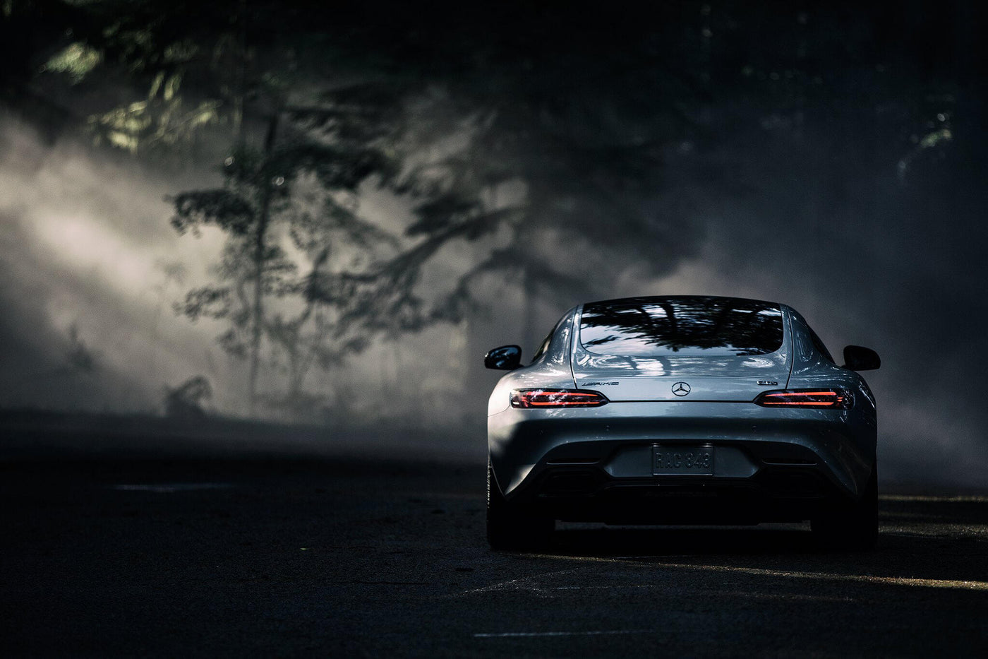 Mercedes-AMG sports car on a tree-lined road