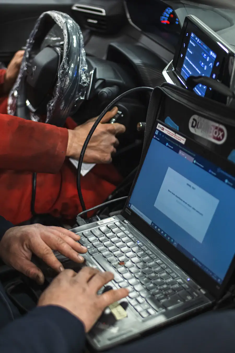 Technician with a diagnostic laptop — talk to Foreign Automotive Trinidad